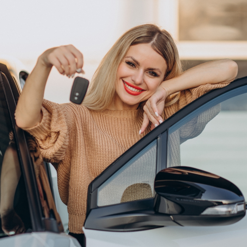 Woman holding keys from her new car