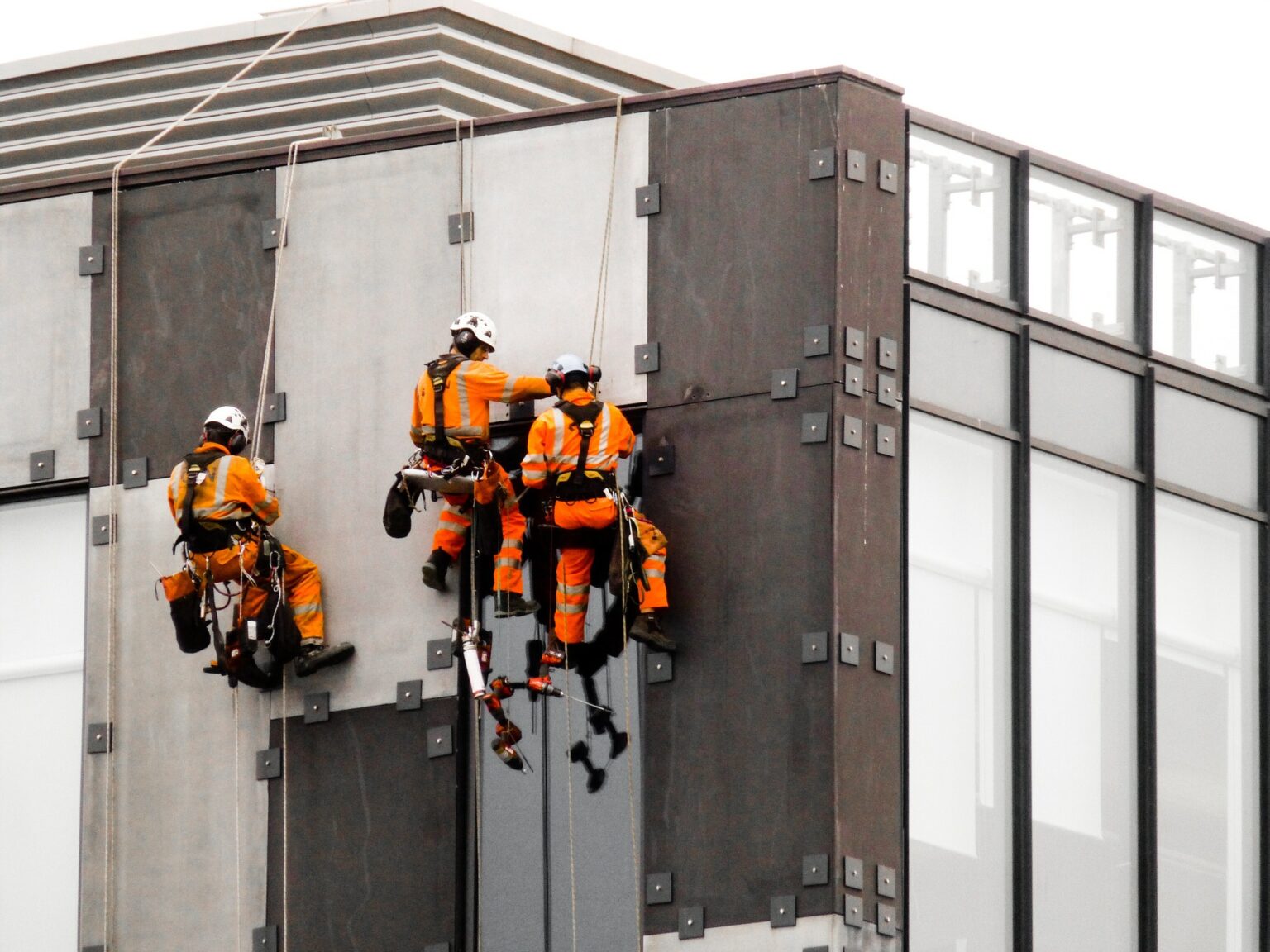 Three workmen working safely