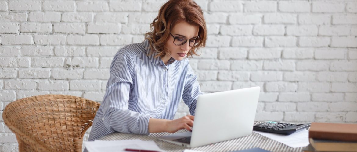 Young woman freelancer works at the computer.