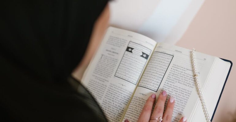 person in black hijab holding white printer paper