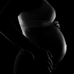 gray scale photo of a pregnant woman