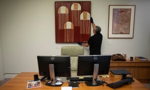 Collection management officer Dave Roberts hangs Kedervent (Jelly Fish Story) by Lisa Michl Ko-manggén in Sussan Ley’s office. Ley eyed off the work when it was hanging in Ken Wyatt’s office.