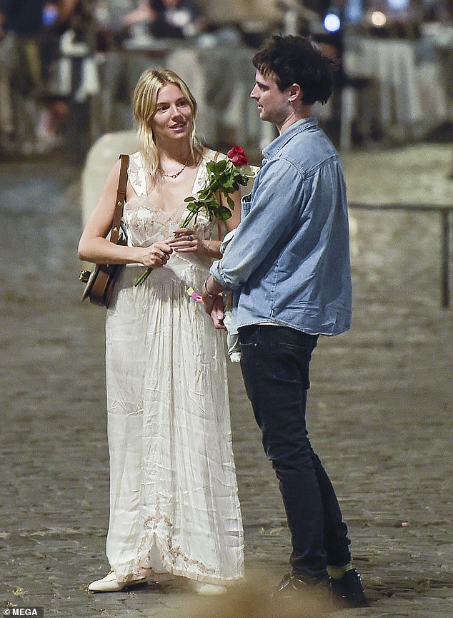 Sweet gaze! Sienna was deep in chat with her beloved ex as they hit the Italian streets