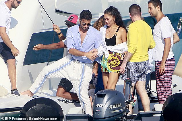 Easy does it! She was gently escorted safely aboard the sea vessel by her friend