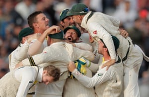 The Australian players celebrate winning.