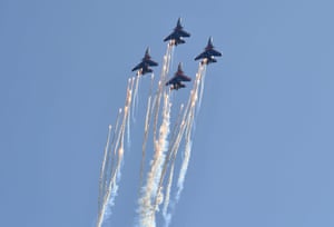 Russian acrobatic team members perform before the race.
