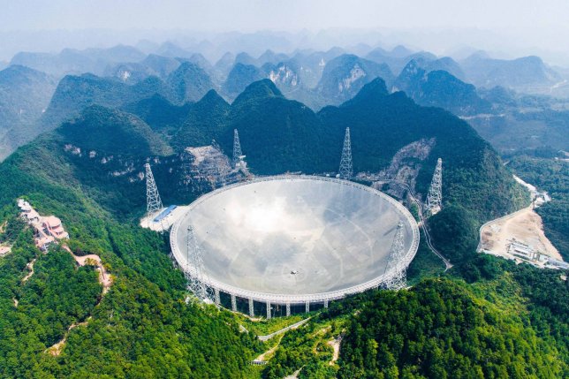 (161208) -- BEIJING, Dec. 8, 2016 (Xinhua) -- Photo taken on Sept. 24, 2016 shows the 500-meter Aperture Spherical Telescope (FAST) in Pingtang County, southwest China's Guizhou Province. The FAST, world's largest radio telescope, measuring 500 meters in diameter, was completed and put into use on Sept. 25. FAST, also called "China's eye of heaven," is the world's largest and most sensitive radio telescope, and China holds the intellectual property rights to it. Work on the nearly 1.2-billion-yuan (180 million U.S. dollars) project started in 2011, and the installation of the telescope's main structure -- a 4,450-panel reflector as large as 30 football pitches -- was finished in early July this year. FAST's tasks include survey of neutral hydrogen in the space, observation of pulsars as well as spacecraft tracking and communications. China achieved major breakthroughs in scientific and technological development in 2016. (Xinhua/Liu Xu) (ry) (Photo by Xinhua/Sipa USA)
