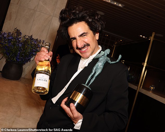 Cheers! Francesco Zecca held his award in one hand and a bottle of champagne in another