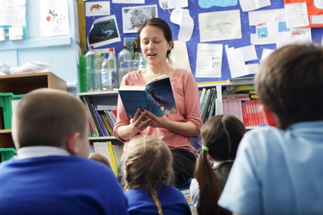 Teacher reading to pupils in class