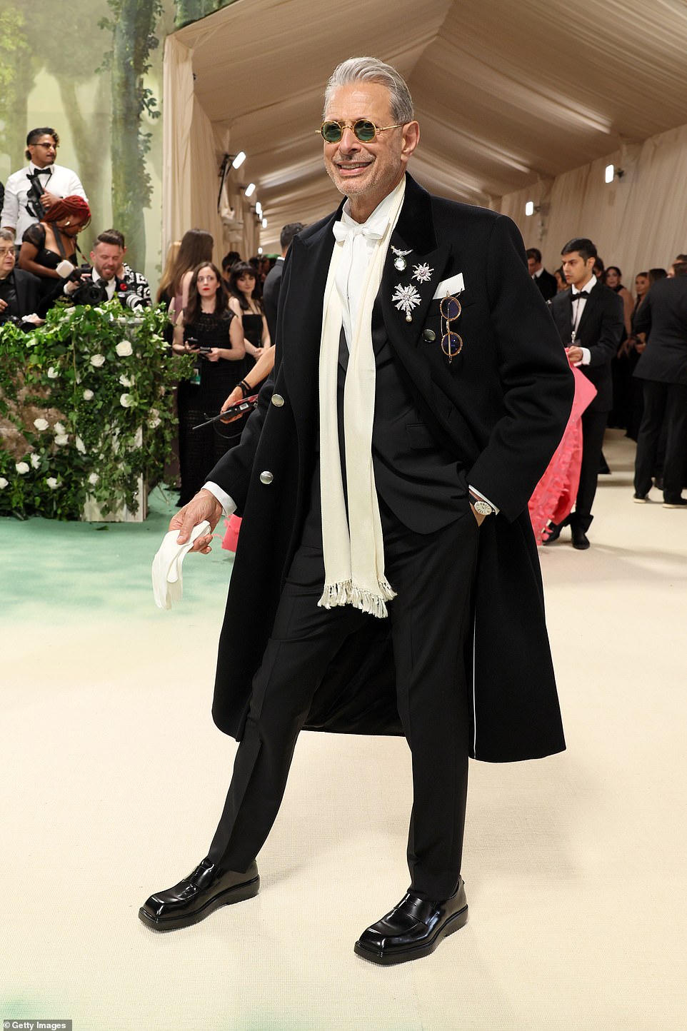 Jeff Goldblum sported a scarf like tie with a long coat, adding diamond pins