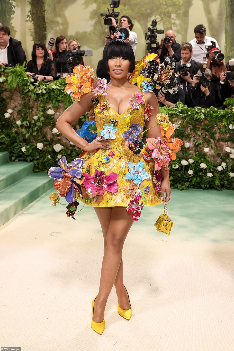 Nicki Minaj wore a yellow mini dress with three-dimensional flowers in different colors throughout