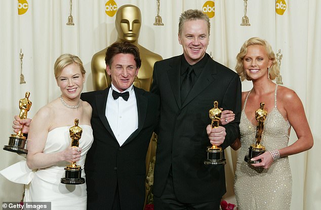 Here Robbins stands a head above, from left, Renee Zellweger, Sean Penn, and Charlize Theron in 2004 at the Oscars