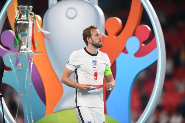 England player Harry Kane walks past the Euro 2020 trophy