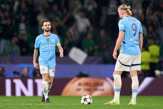 Erling Haaland (right) and Bernardo Silva (left) of Manchester City react after Maxi Araujo of Sporting CP (not in frame) scores his team's second goal during the UEFA Champions League match between Sporting CP and Manchester City 