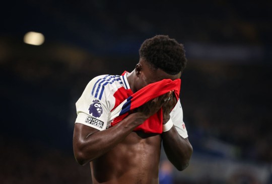 Bukayo Saka of Arsenal looks dejected as he leaves the pitch after picking up an injury during the Premier League match between Chelsea FC and Arsenal FC