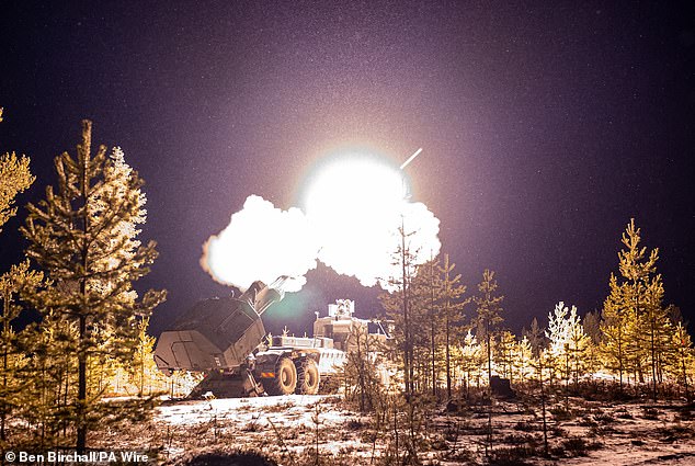 Snowflakes are illuminated during live firing of the British Army's new Archer Mobile Howitzer gun near Rovaniemi in the Arctic Circle