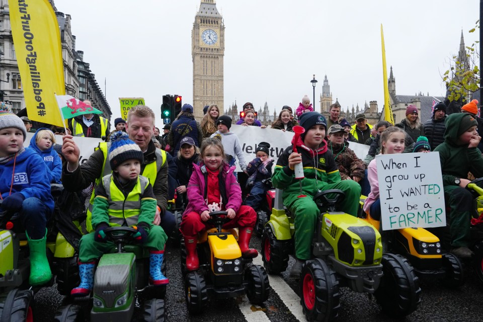 Children ride toy tractors in Parliament Square as demonstrators attend a rally this week