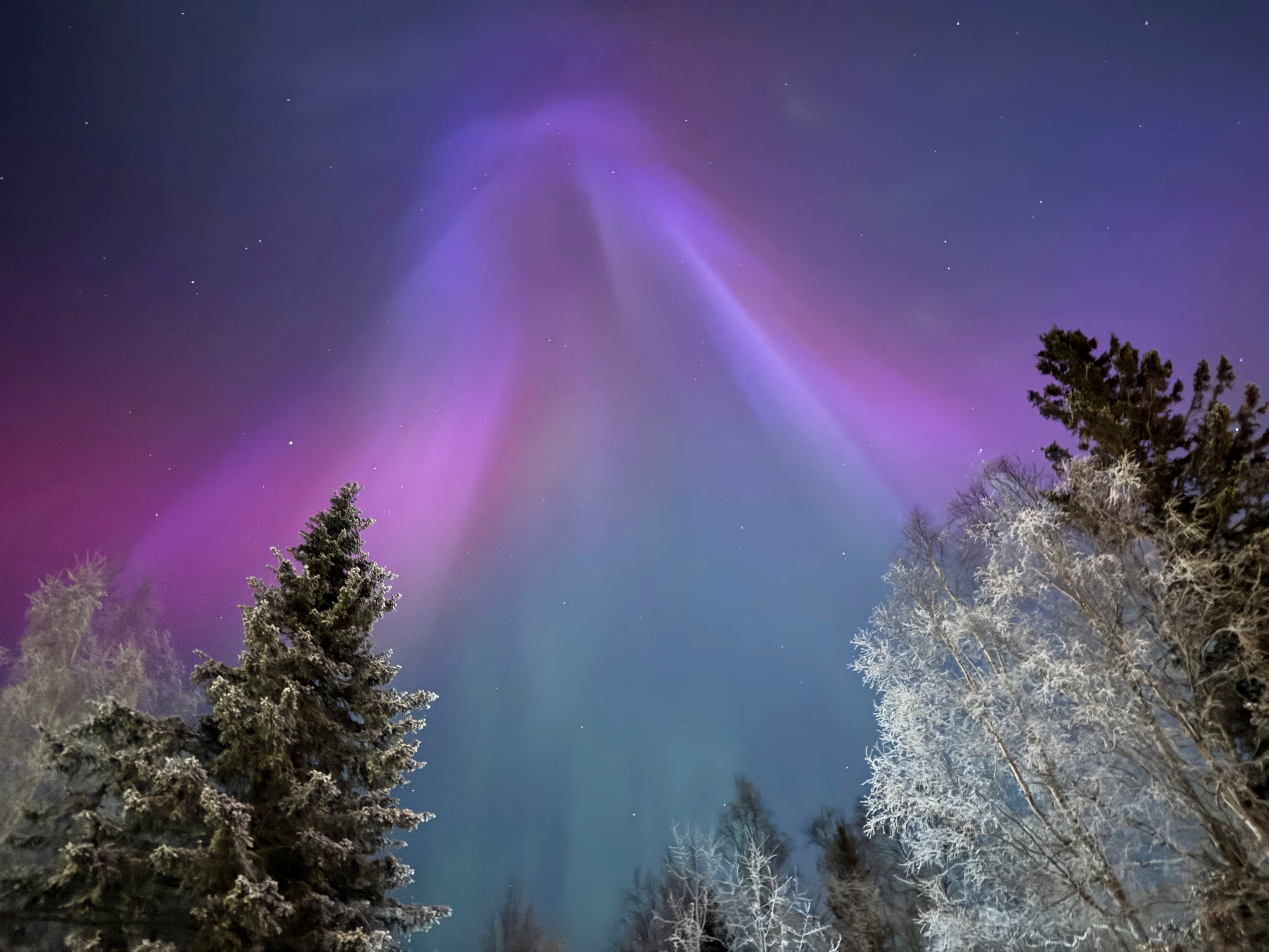 The northern lights appear over Anchorage, Alaska, on Wednesday. The Space Weather Prediction Center says a minor geomagnetic storm is likely to impact Earth over the weekend, bringing the potential for more dazzling skies