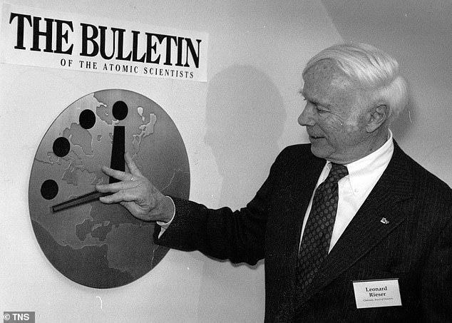 The Doomsday Clock was unveiled in 1947 and has since become a measure of humanity's proximity to a human-caused apocalypse. Each year, a panel of scientists update the clock to reflect how close the world is to disaster, represented by midnight. Pictured: Dr Leonard Rieser, Chairman of the Board of the Bulletin of the Atomic Scientists moves the hand of the Doomsday Clock back to 17 minutes before midnight in 1991