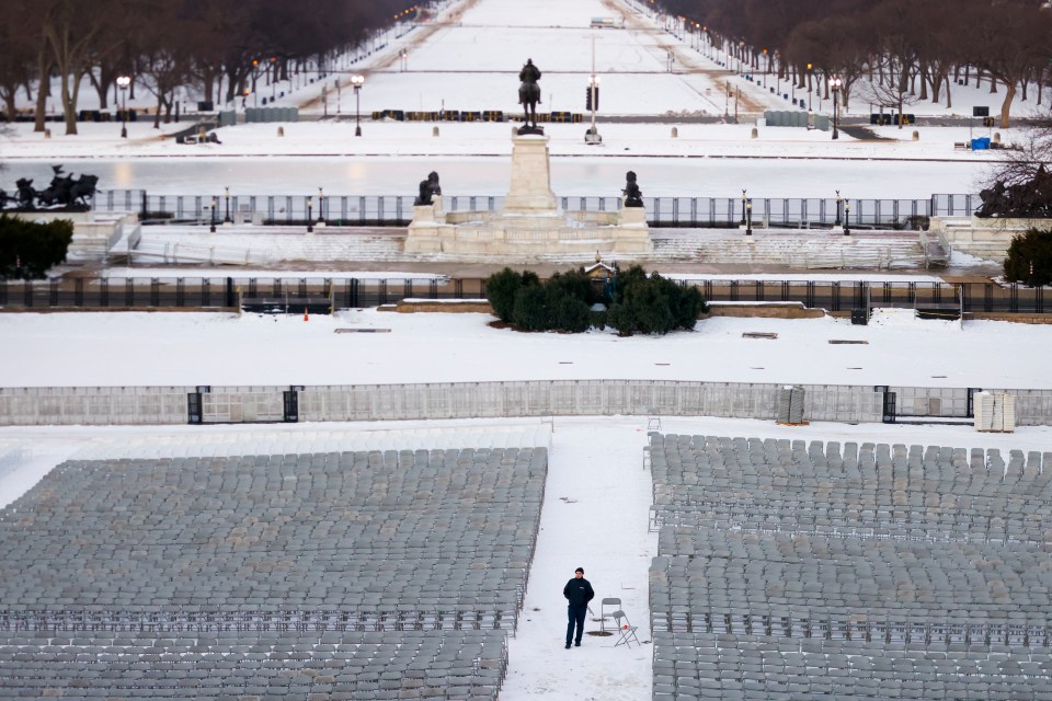 Empty chairs set up in the snow for a presidential inauguration.