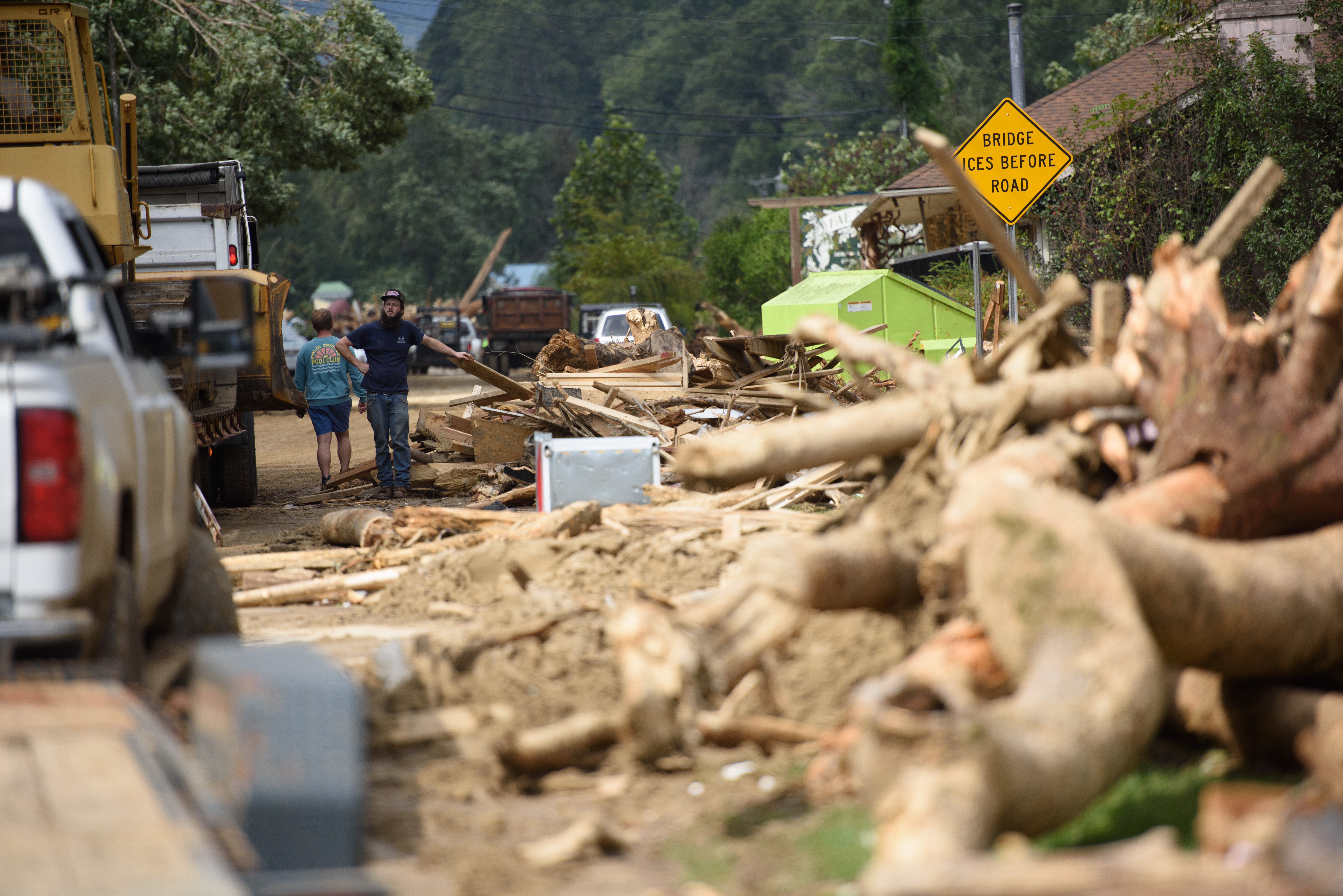 People navigate through debris after heavy rains from Hurricane Helene last September in Lake Lure, North Carolina. Climate change worsened by fossil fuel emissions is making hurricanes faster and stronger