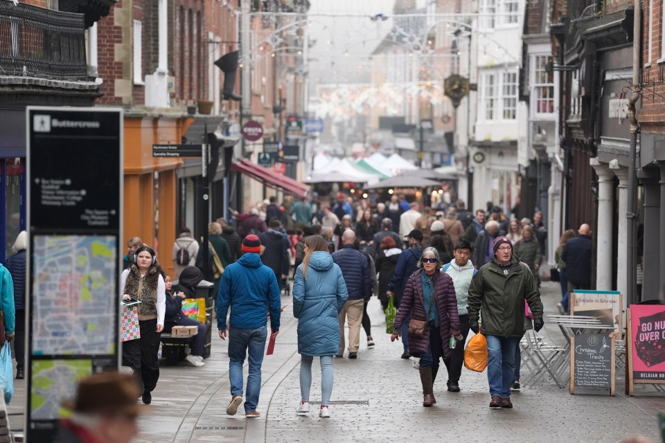 Christmas Eve shoppers on a busy high street.