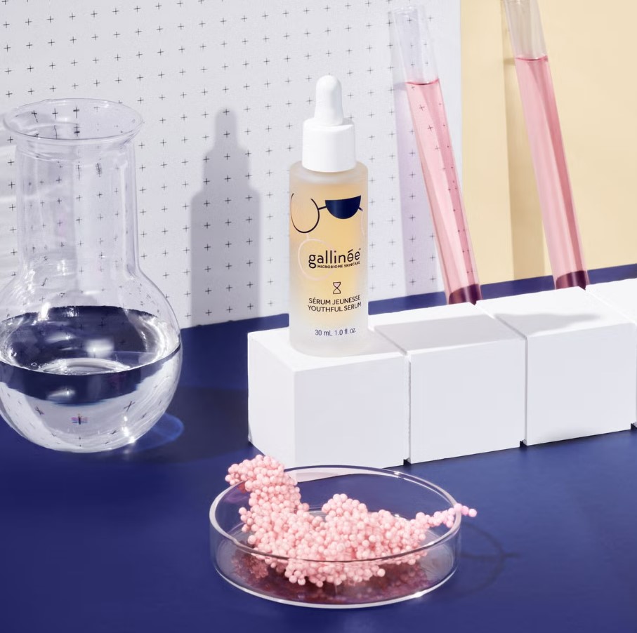 Gallinée Youthful Serum bottle with lab equipment.