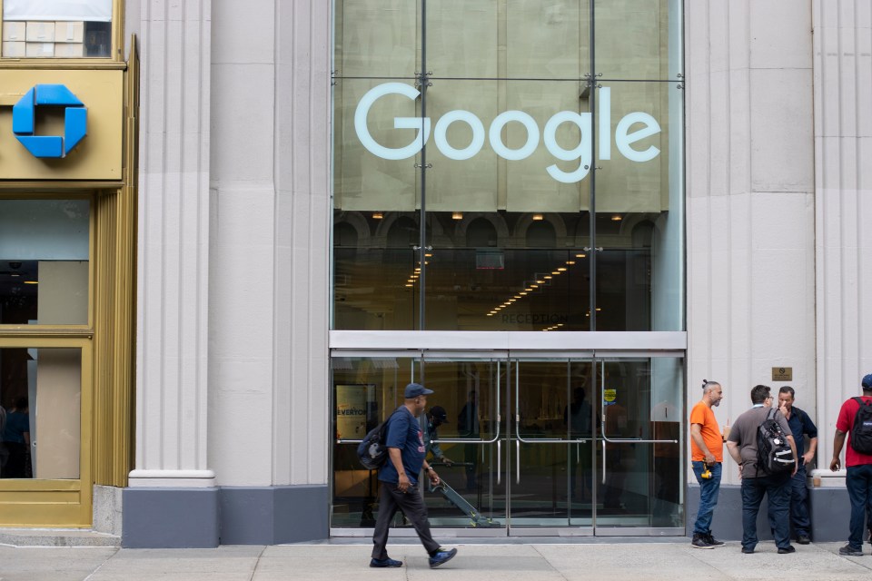 Man walking past a Google office building in New York City.