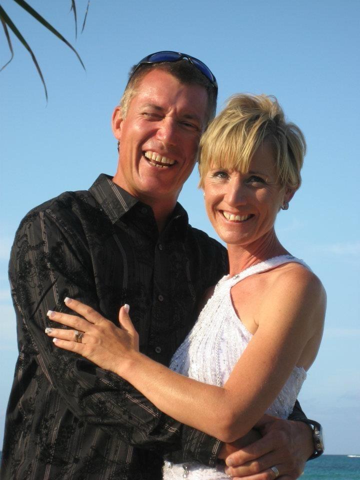 Portrait of a smiling couple embracing outdoors.