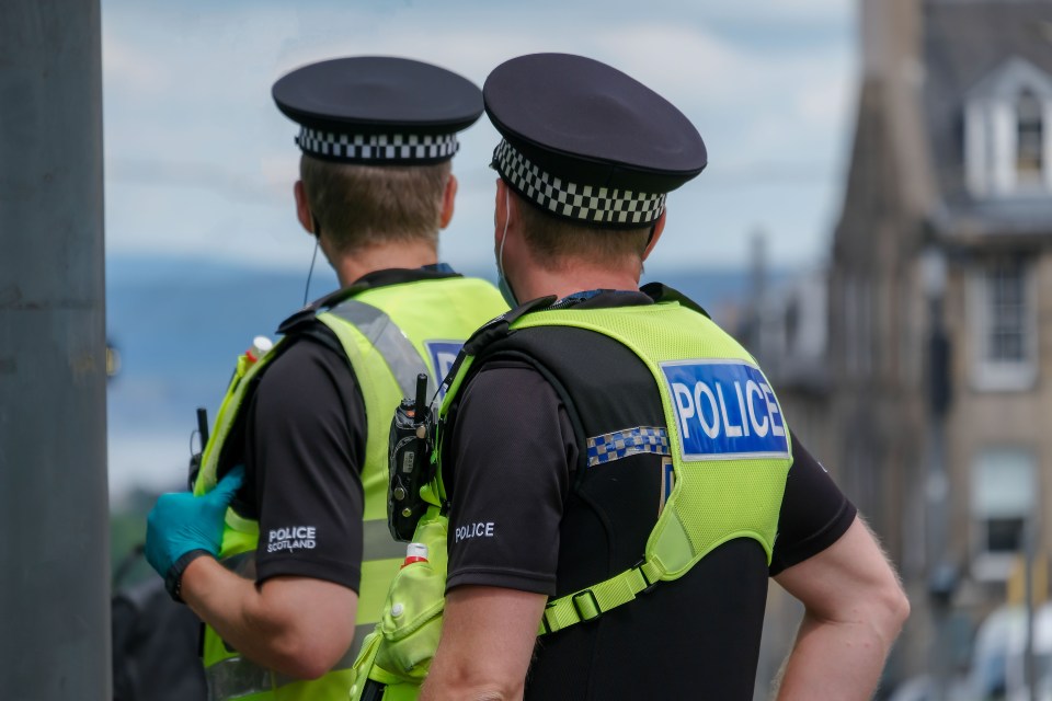 two police officers are standing next to each other