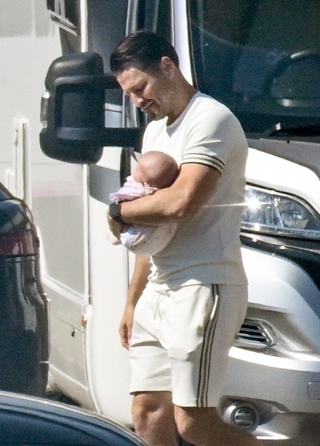 Mark Wright holding his baby daughter.