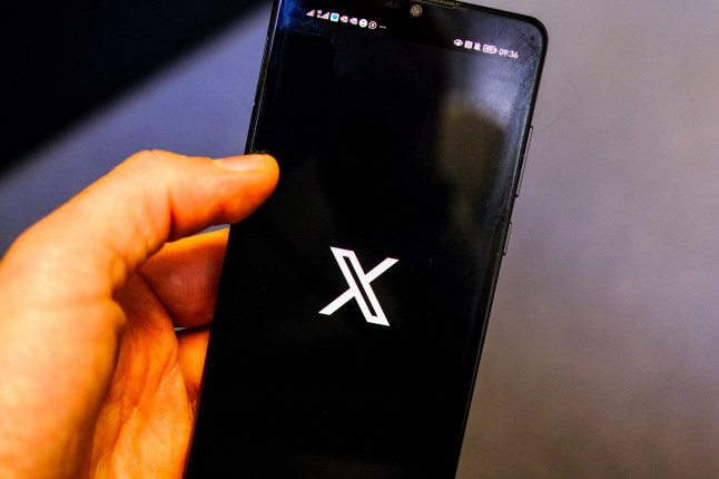 Illustration of the finger of an Internet user who is looking and preparing to open the X application (exTwitter) on his smartphone, in Valence, France, January 16, 2025. (Photo by Nicolas Guyonnet / Hans Lucas / Hans Lucas via AFP) (Photo by NICOLAS GUYONNET/Hans Lucas/AFP via Getty Images)