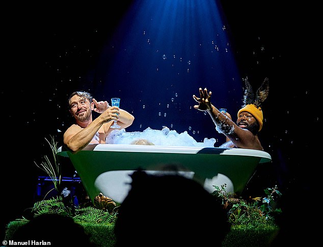 Making a splash: Oberon (J.J. Feild) and Bottom (Emmanuel Akwafo) bond in the bath, in Nick Hytner's teasing, gently gender-swapping twist on A Midsummer Night's Dream