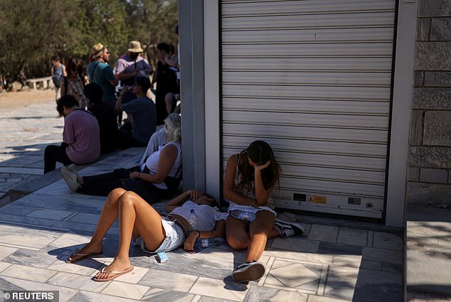 People sit in the shade near the Acropolis, with 40C expected in Greece on Wednesday