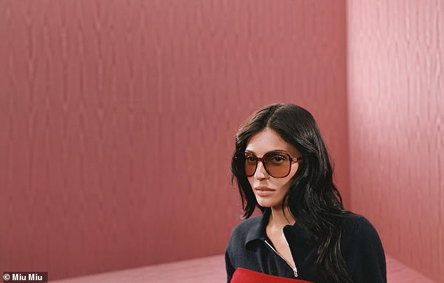 She held a sleek black purse and completed the ensemble by adding a pair of large, circular shades