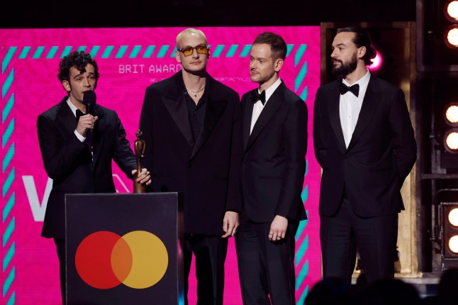 LONDON, ENGLAND - FEBRUARY 11: EDITORIAL USE ONLY The 1975 accept the award for Group of the Year on stage during The BRIT Awards 2023 at The O2 Arena on February 11, 2023 in London, England. (Photo by John Phillips/Getty Images)