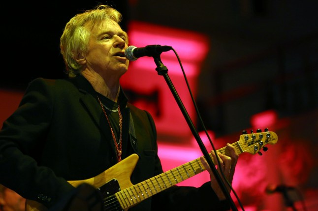 Dave Edmunds playing guitar and singing onstage in 2014