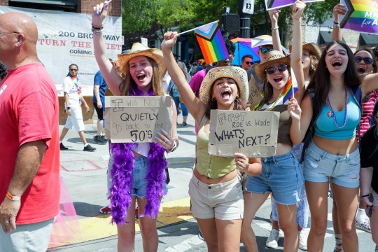  Participants attend the Nashville Pride parade on June 25, 2022 in Nashville, Tennessee in cowboy hats. 