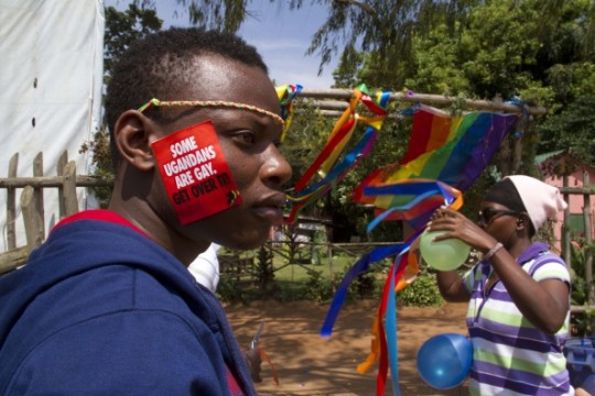 A man in Uganda wears a 'Some Ugandans are gay. Get over it!' sticker. 