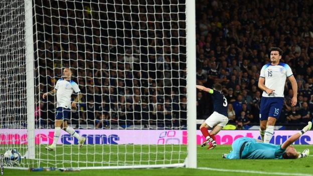 Harry Maguire (right) scores an own goal while playing for England against Scotland