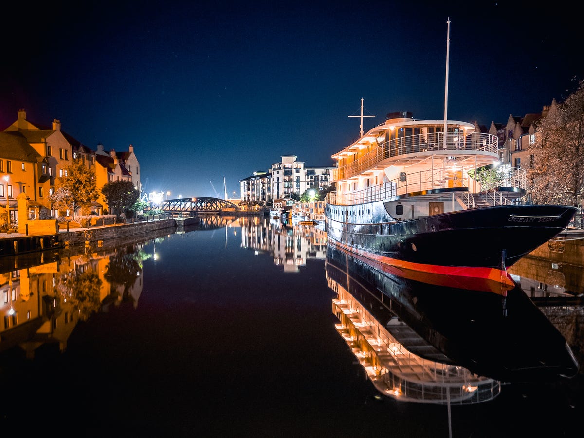 boats on a quay lit up at night