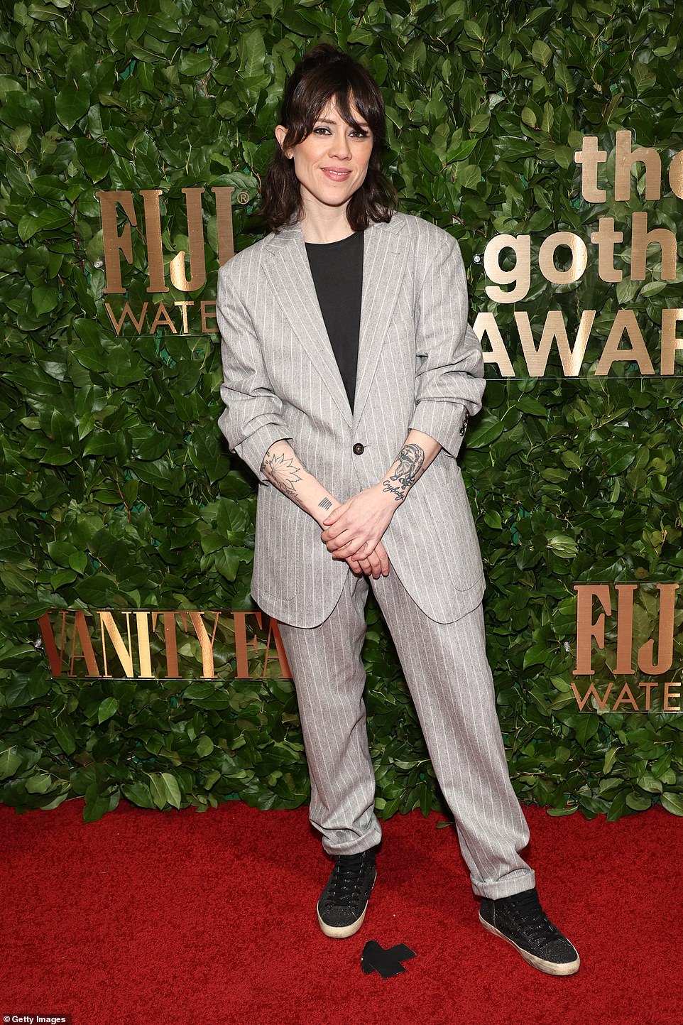 Tegan Quin wore a grey and white striped suit and sneakers