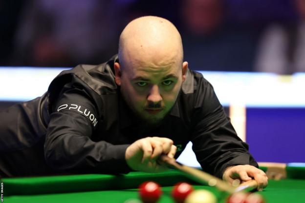 World champion Luca Brecel prepares to play a shot at the UK Championship