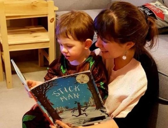 Sarah Whiteley reading a story book (Stick Man) to her son, Theo
