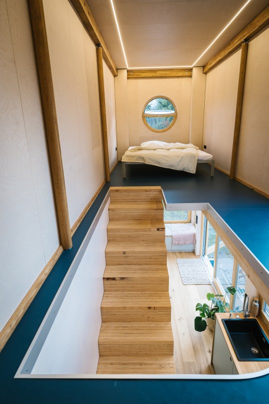 The bedroom with wooden stairs