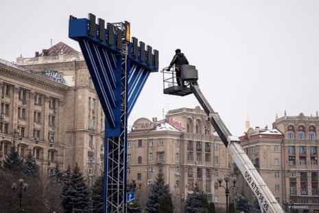 Workers set up a menorah for celebrations marking the Jewish festival of Hanukkah in Kyiv.
