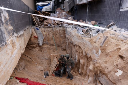 Israeli soldiers at the entrance of a tunnel at Al Shifa hospital compound in Gaza City, amid the ongoing ground operation of the Israeli army against Palestinian Islamist group Hamas in the Gaza Strip, 22 November. This set of images was reviewed by the IDF as part of conditions of the embed, no photos were removed