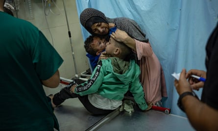 Palestinians wounded in Israeli bombardment of the Gaza Strip are brought to a hospital in Khan Younis, 15 November.