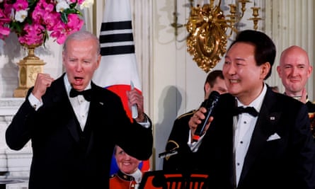 US president Joe Biden reacts as South Korea’s president, Yoon Suk Yeol, sings at an official state dinner given during the president’s state visit, at the White House in Washington, 26 April.