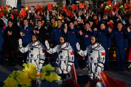 Astronauts Jiang Xinlin, Tang Shengjie and Tang Hongbo wave before boarding the Shenzhou-17 spacecraft at the Jiuquan satellite launch centre in the Gobi desert, north-west China, 26 October